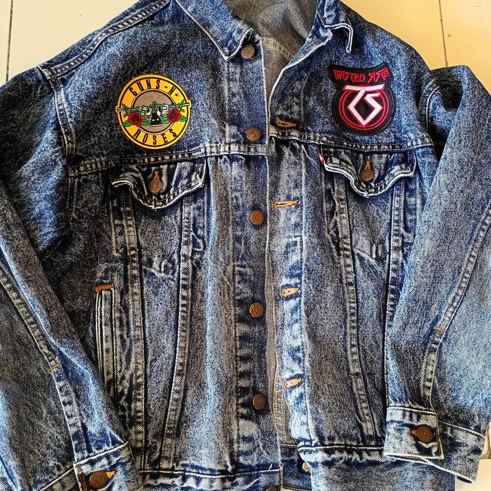 Vintage 1980'S Levi's jean jacket with rock band patches on it. Size large.